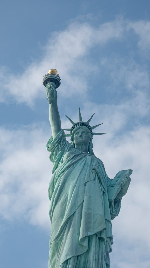Iconic Statue of Liberty towering against a clear blue sky in New York City.